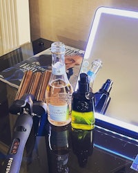 a mirror with a hairdryer and other items on it