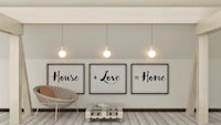 a room with three framed signs saying house love home